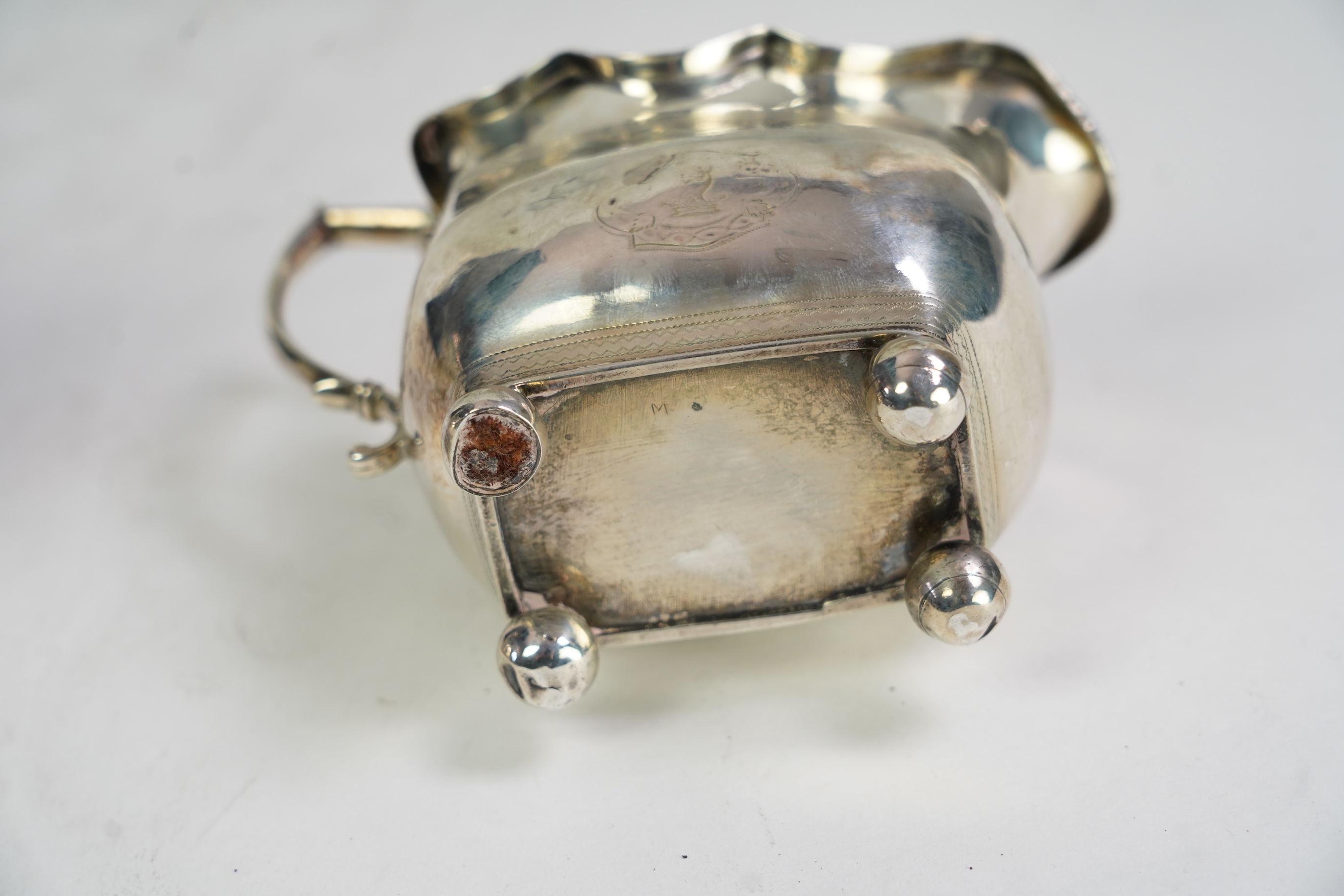 A George III Irish silver two handled sugar bowl, by Richard Sawyer, Dublin, 1808, 18.4cm over handles, with engraved armorial, on four ball feet, together with a similar cream jug, by Daniel Egan, Dublin, 1811, 16.2oz.